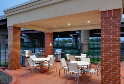 Inviting outdoor patio with multiple grilling stations and open-air seating.