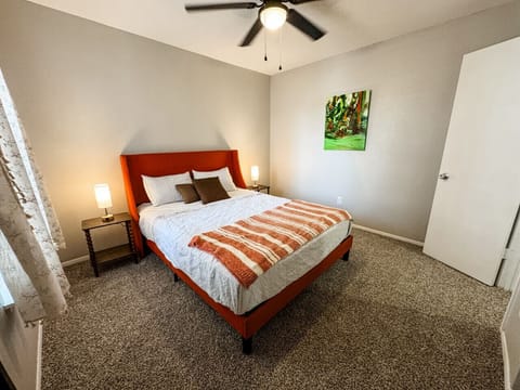 Cozy bedroom featuring a comfortable bed and warm, inviting decor