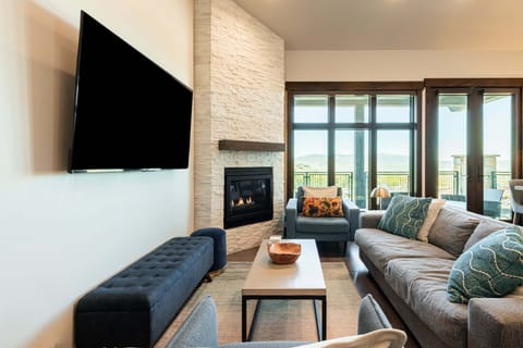 Cozy living room with fireplace and mountain views