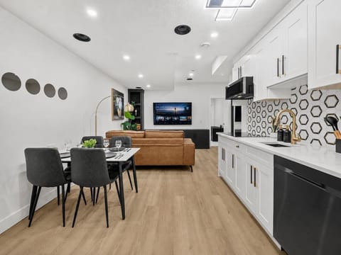 Modern open-concept kitchen and living room with premium appliances and seating