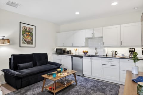 Relax in this stylish studio retreat featuring a sleek kitchenette, cozy lounge space, and everything needed for a comfortable stay.