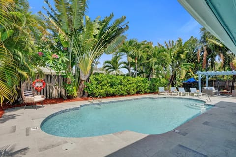 Resort-style pool framed by beautiful tropical landscaping