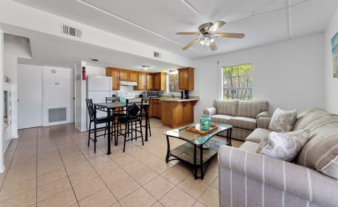 Open living, dining, and kitchen area with comfortable seating and plenty of room to relax after a day at the beach