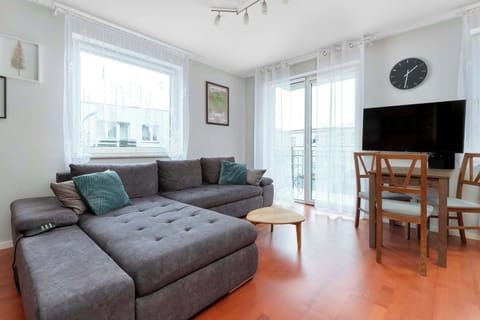 Bright living room with corner sofa and wooden furniture