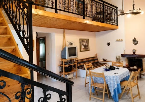 Bright and spacious living area featuring warm wooden details and comfortable seating. Ideal for relaxing with family or friends after a day exploring Evia and nearby beaches