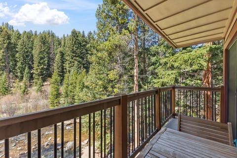 Step onto your private deck and breathe in the fresh pine-scented air while gazing at towering evergreens and the peaceful creek below, your serene mountain escape awaits.