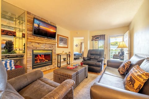 Sink into plush seating by the glowing fireplace, gather for movie nights, and step outside to your private balcony—your cozy mountain retreat awaits.