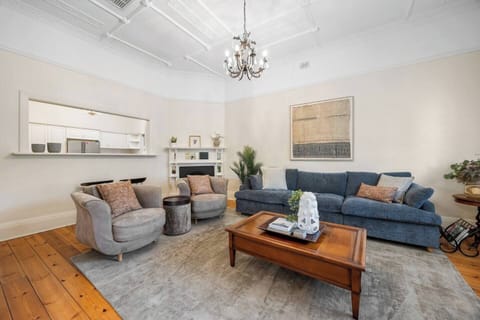 Soft textures, warm timber tones, and layered heritage details create a calming living area designed for slow mornings with coffee or relaxed evenings spent unwinding together.