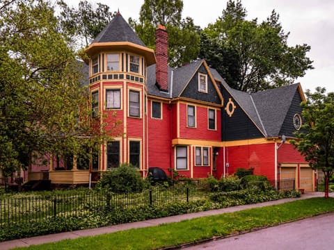 Striking Victorian red home w/ lush landscaping — a head-turning retreat full of character
