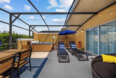 Step onto the spacious terrace with stylish loungers that beckon you to relax under the blue sky. Gather around the dining table in the evening, where soft string lights create a warm ambiance, perfect for unwinding.