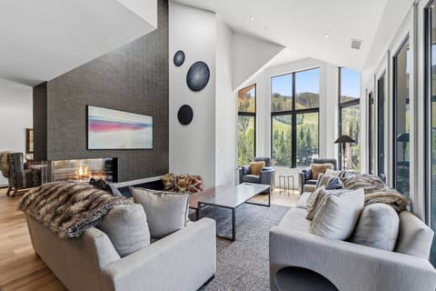 Elegant living room with smart TV, fireplace, and unparalleled views