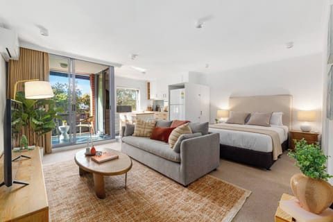 Settle into a bright open-plan studio where the living, sleeping, kitchen, and balcony spaces flow together in a calm, contemporary setting designed for easy city stays.