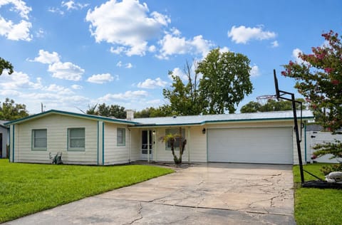 Spacious single-story home with large driveway, garage, and front yard