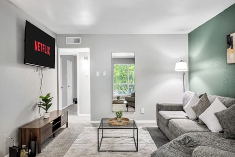 Spacious and inviting living area with comfortable seating and a smart TV, perfect for relaxing after exploring Arlington or attending events at AT&T Stadium.