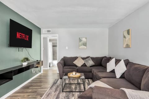 Spacious and inviting living area with comfortable seating and a smart TV, perfect for relaxing after exploring Arlington or attending events at AT&T Stadium.