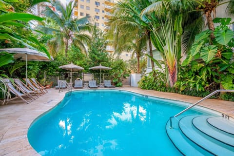 Dive into a tropical oasis pool framed by greenery