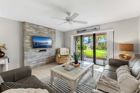 Bright & airy living room with sliding glass doors that leads to ground floor outdoor patio