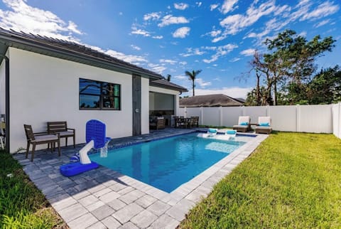 A private backyard oasis featuring a sparkling pool and sun-soaked patio.