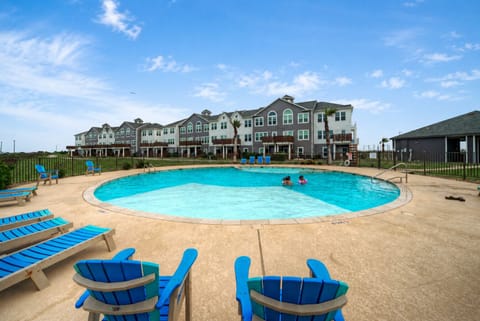 Enjoy a refreshing swim at the spacious community pool with plenty of lounge seating nearby.