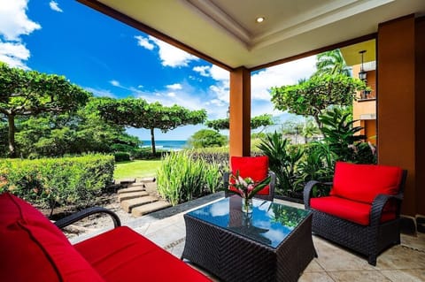 Luxury beachfront condo in Playa Langosta, Tamarindo, Costa Rica. Private ocean view balcony with outdoor seating, tropical gardens, infinity edge pool, and direct beach access. Steps from surf, restaurants, shops, and premium vacation rental condo.