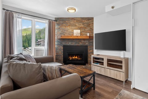 Settle into plush seating by your cozy fireplace and enjoy stunning mountain views from your window—your perfect alpine retreat awaits.