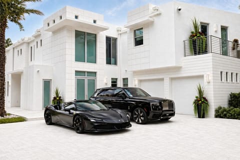 Front exterior with driveway parking, garage access, and contemporary architectural design