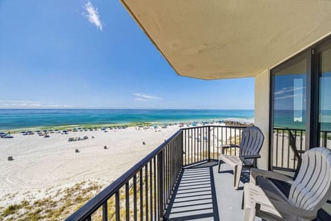 Spacious Gulf-front balcony with comfortable seating and panoramic beach views.