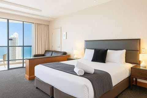 Spacious bedroom with a superking bed, balcony access, and stunning skyline views