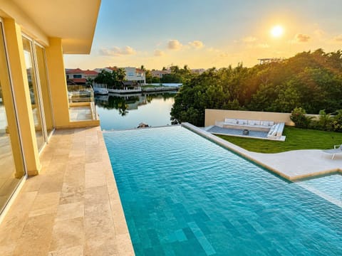 Relax by the pool with peaceful canal views at sunset