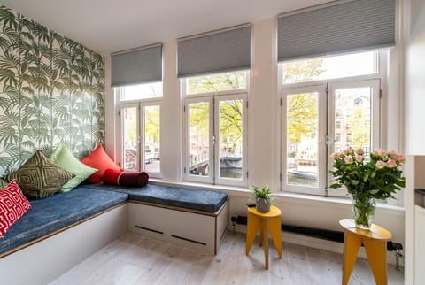 Canal-side reading nook framed by Amsterdam views.