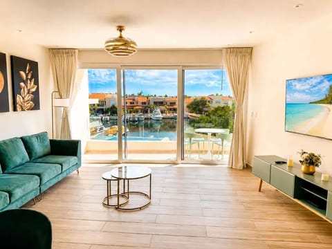 Bright living room with marina canal views, pool, and private terrace.