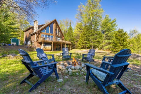 Enjoy cozy evenings under the stars with Adirondack seating and beautiful forest views surrounding the cabin.