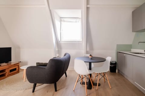 The living area offers comfortable seating in a bright and open setting.