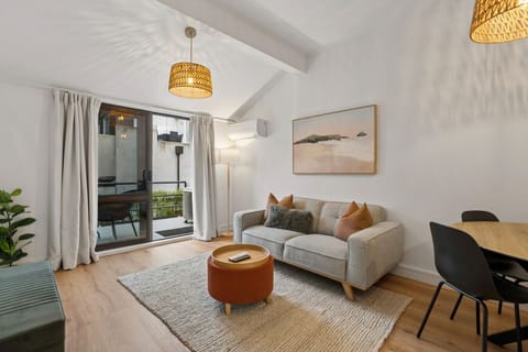 Living Room: Bright and stylish haven with modern decor and balcony views, your perfect retreat!