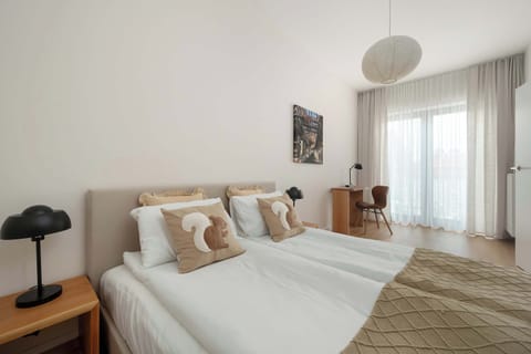 A bright bedroom with a double bed, bedside tables, and soft neutral décor creating a relaxing atmosphere.