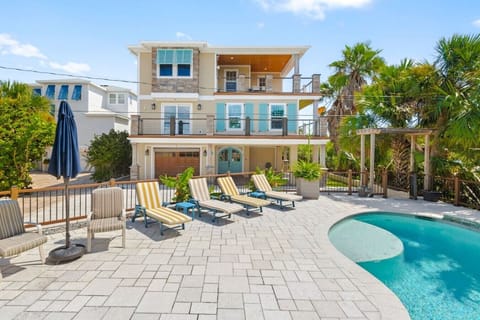 Discover one of the best backyards in St. Augustine: Pool, hot tub, dual fire pits, putting green, outdoor kitchen & outdoor shower.