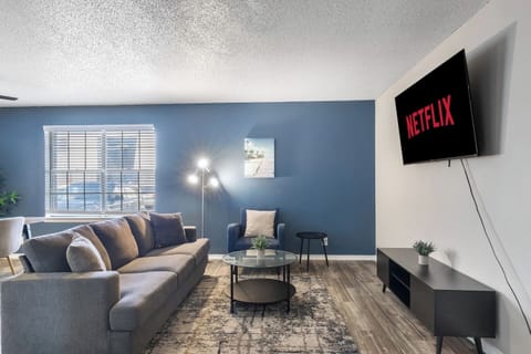 Spacious and inviting living area with comfortable seating and a smart TV, perfect for relaxing after exploring Arlington or attending events at AT&T Stadium.