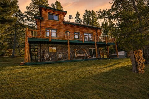 Escape to this classic mountain log cabin featuring expansive decks, peaceful alpine surroundings, and stunning Rocky Mountain views.