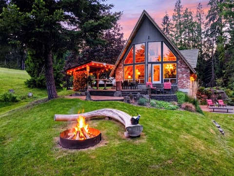 End the day by the firepit as the A-frame glows against a peaceful Whidbey Island sunset.