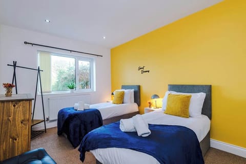 Bright twin room with cosy bedding, pops of colour, and plenty of space for a comfortable stay.
