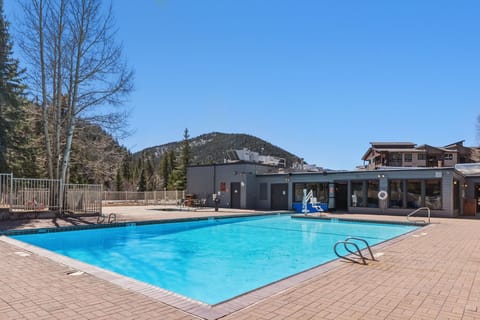 The outdoor pool awaits, surrounded by mountain views — guests are a quick walk to the amenities available at Keystone Lodge & Spa