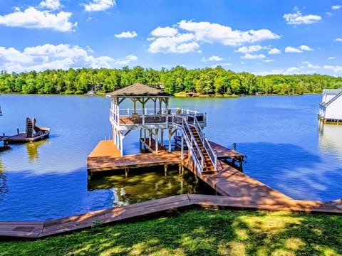 Waterfront - The dock stretches out into calm cool-side water, two boat slips beneath.