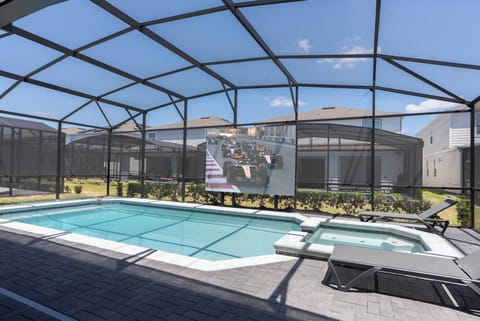 Step outside to your private pool area, featuring a sleek screen enclosure for privacy and sunshine. The turquoise water sparkles under the sun, and cozy lounge chairs await you to relax and enjoy the warmth.