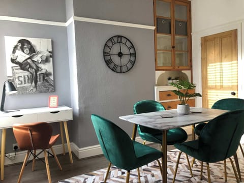 Dining Room: Bright and stylish space featuring vibrant chairs and unique art for memorable meals!