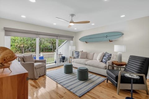 Picture yourself unwinding in this breezy coastal living room, where beach-inspired décor and soft seating invite you to relax after a day of seaside adventures.
