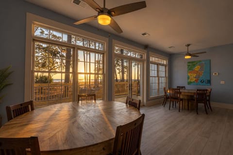 Golden hour floods the dining room at 152 Ave of Oaks — where sunset views, warm hardwoods & ocean breezes make every evening feel like a private escape on Hilton Head's most coveted shores.