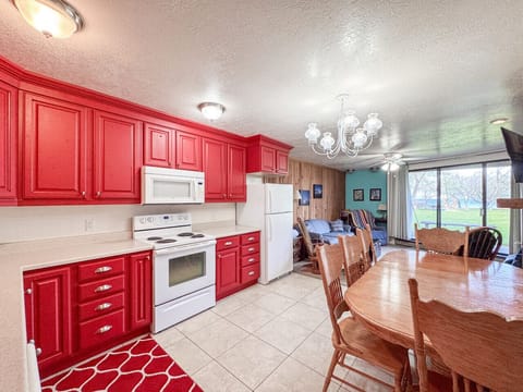 Bright, spacious dining area with lake views and vibrant kitchen perfect for family gatherings.