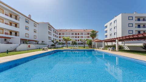 Sun-ready Vilamoura T1 with shared outdoor pool and lush gardens. #Vilamoura #AlgarveStay #Pool