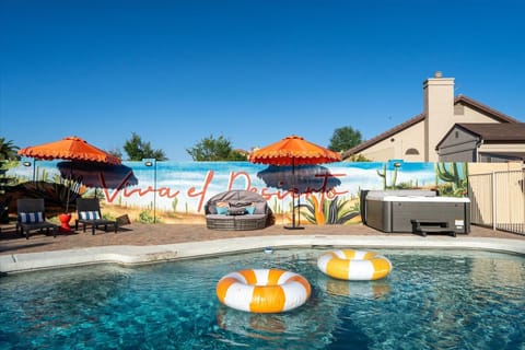 Sun, floaties, hot tub, and a mural that sets the scene — welcome to vacation mode.