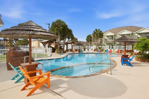 Resort Pool & Hot Tub — Freeform Pool, Colorful Adirondack Chairs, Tiki Umbrellas & Rock Waterfall